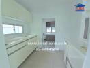 Modern white kitchen with ample storage and counter space