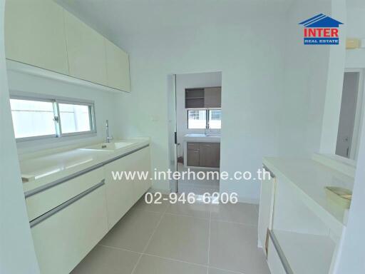 Modern white kitchen with ample storage and counter space