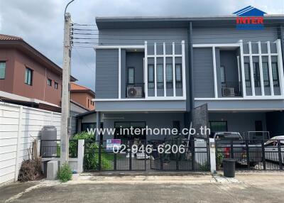 Modern townhome exterior with gates and driveway