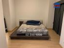 Double bed in a bedroom with wooden flooring and curtains