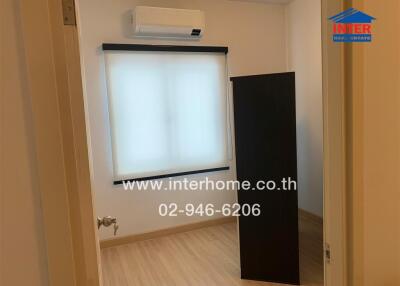 Small bedroom with window and air conditioner