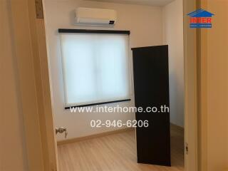 Small bedroom with window and air conditioner