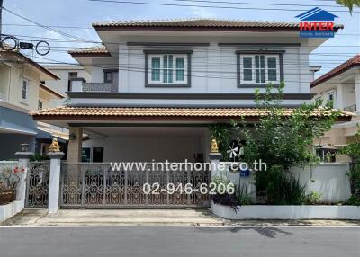 Front view of a two-story house with a gated driveway