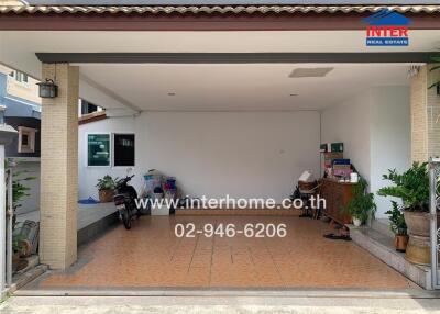 Spacious garage area with tiled floor and storage