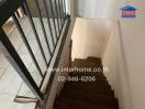 Staircase with tiled floor and railing leading to a lower floor.