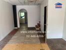 Interior view showing hallway with mixed flooring and arched doorway