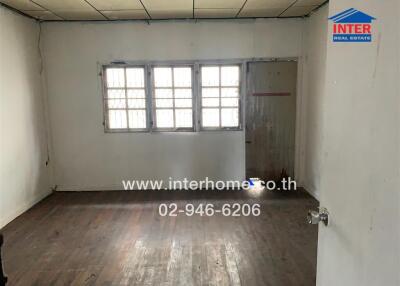 Empty bedroom with wooden floor and window