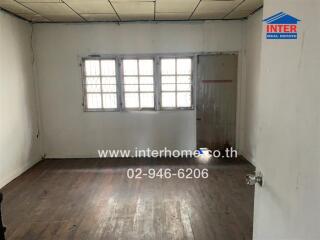 Empty bedroom with wooden floor and window