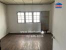 Empty bedroom with wooden floor and window