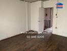 Interior view of a room with wooden flooring and open door