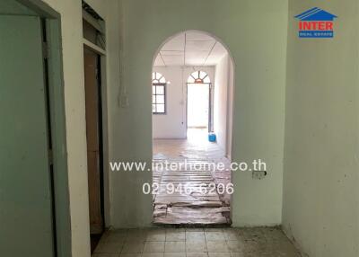 Interior hallway with tiled floor and arched doorway