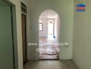 Interior hallway with tiled floor and arched doorway