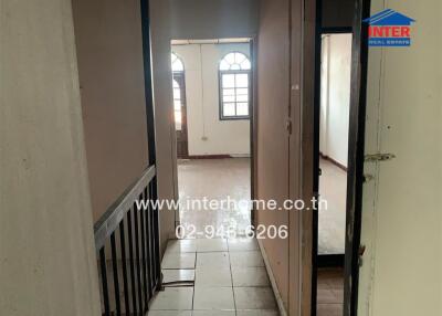 View of a hallway leading to a room with arched windows