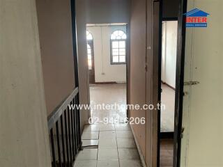 View of a hallway leading to a room with arched windows