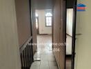 View of a hallway leading to a room with arched windows