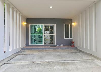 Covered garage or carport with sliding glass door and lights