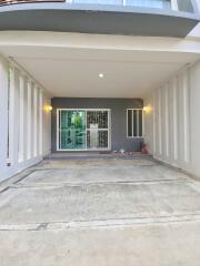 Covered garage or carport with sliding glass door and lights