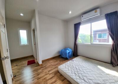 Bright bedroom with wood flooring and natural light