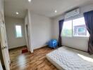 Bright bedroom with wood flooring and natural light