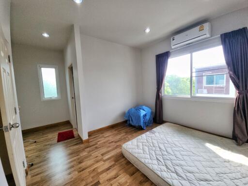 Bright bedroom with wood flooring and natural light