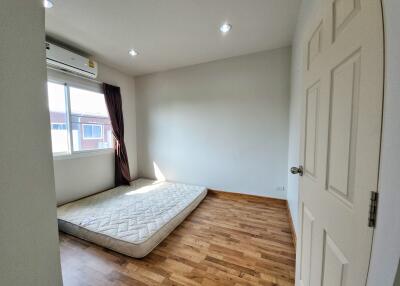 Minimalist bedroom with hardwood floors