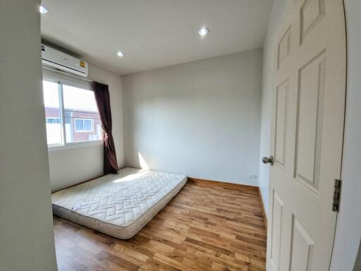 Minimalist bedroom with hardwood floors