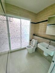 Modern bathroom with sliding glass door and floral frosted glass