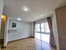 Bright living room with wooden flooring and large windows