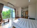 bright bedroom with large windows and balcony access