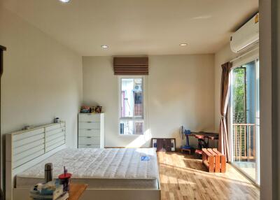 Spacious bedroom with large window and balcony access