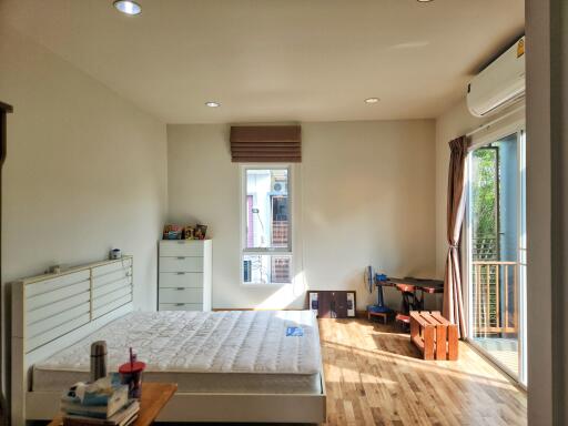 Spacious bedroom with large window and balcony access