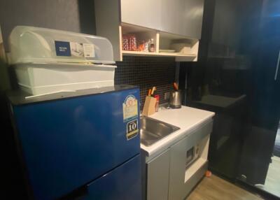 Compact modern kitchen with blue refrigerator