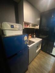 Compact modern kitchen with blue refrigerator