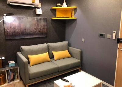 Cozy living room with a gray sofa and yellow accents