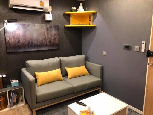 Cozy living room with a gray sofa and yellow accents