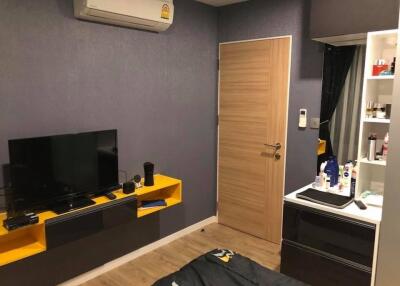 Modern bedroom with wall-mounted TV and storage