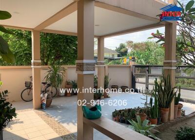 Patio area with plants and a view of the street