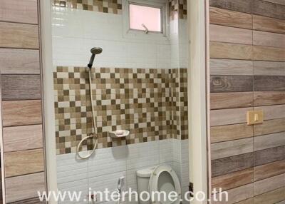 Small bathroom with tiled walls