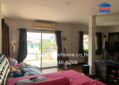 Bedroom with large sliding glass door and balcony view