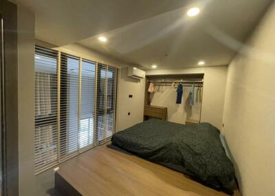 Bedroom with bed, closet, and large windows