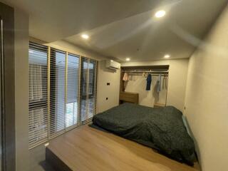 Bedroom with bed, closet, and large windows