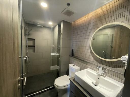 Modern bathroom with shower, toilet, and sink