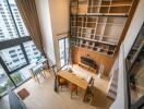 Modern living room with tall windows, open shelves, and a loft-style design