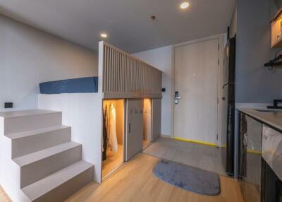 Modern studio apartment with elevated bed and built-in storage