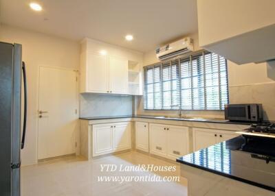 Modern kitchen with white cabinets and appliances