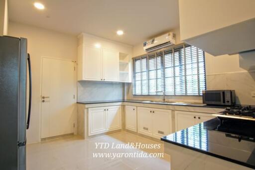 Modern kitchen with white cabinets and appliances