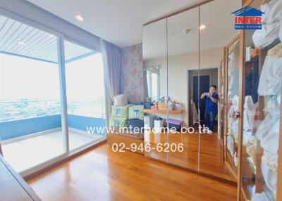 Spacious bedroom with mirrored wardrobe and balcony