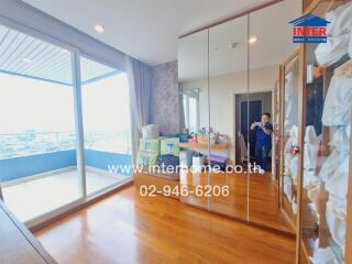 Spacious bedroom with mirrored wardrobe and balcony