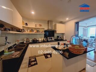 Modern kitchen with black countertops and white cabinets