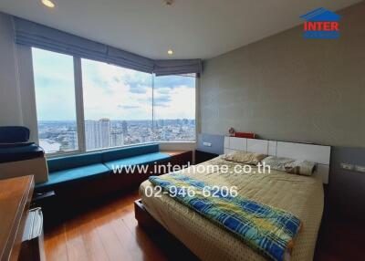 Bedroom with large windows and city view